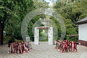 Wedding ceremony in outside, rustik style. White door arch in green tree background