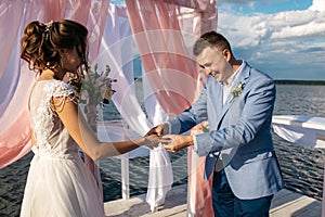 Wedding ceremony on the pier in the middle of the lake