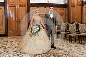 Wedding ceremony. Registry office. A newly-married couple signs the marriage document.Young couple signing wedding documents