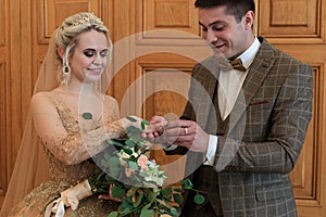 Wedding ceremony. Registry office. A newly-married couple signs the marriage document.Young couple signing wedding documents