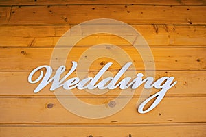 Wedding Ceremony sign on the wall of a wooden house