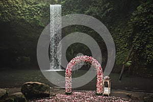 Wedding ceremony on small secret waterfall Tibumana in Bali, Indonesia jungle