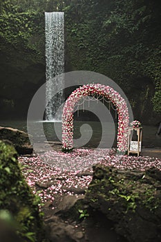 Wedding ceremony on small secret waterfall Tibumana in Bali, Indonesia jungle