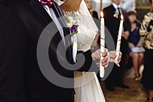 Wedding ceremony of stylish elegant brunette bride and groom win the old church