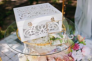 Wedding ceremony, table and decor for a wedding ceremony, a box for wedding rings, fresh flowers
