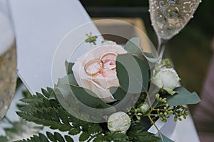 Wedding ceremony table with glasses and rings