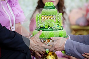 Wedding ceremony in Thai culture. Flower and Candle design on tray for Bride and groom paying respects to the Elders in Thai weddi
