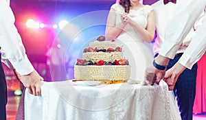 Wedding ceremony. Waiters serving wedding cake