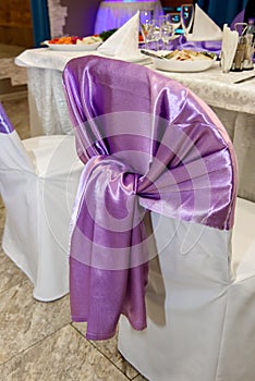 Wedding chair with purple bow.