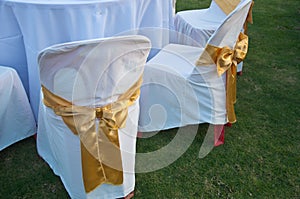 Wedding chairs with golden color ribbon