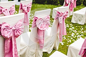 Wedding chairs with pink bows