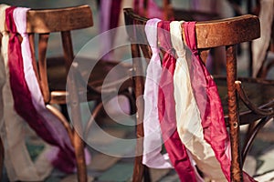 Wedding chairs with tapes,wedding ceremony in outside.rustik style. White door arch in green tree background