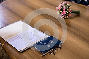 Wedding civil german marriage Register with Pen and Bouquet of Fresh Beautiful Flowers on Wooden Table.