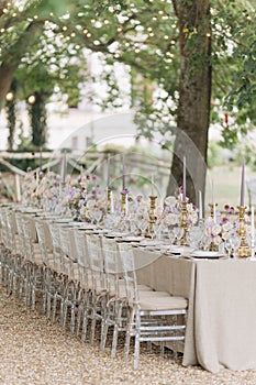 Wedding in classic style. Wedding table in natural tones with luxurious settin, bouquets of roses,