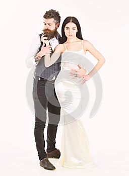 Wedding concept. Couple in love, bride and groom in elegant clothes, white background. Bearded hipster with attractive