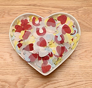 Wedding confetti in heart shaped bowl