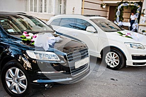 Wedding cortege of black and white cars