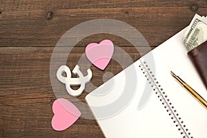 Wedding Costs Concept. Hearts, Pen, Paper, Money On Wood Background