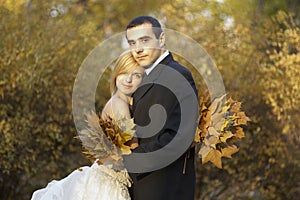 Wedding couple at the autumn park.Beautiful married couple in the wedding day