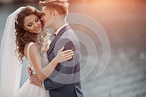 Wedding couple in a beautiful place by sea and mountains, Bride and groom on beach