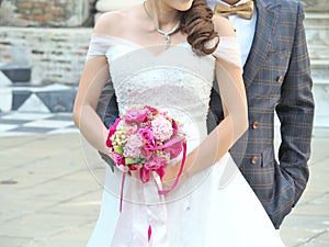 Wedding couple with bridal bouquet.