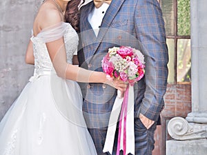 Wedding couple with bridal bouquet.