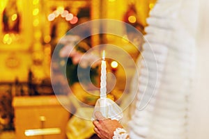 Wedding couple in church with candle in hands
