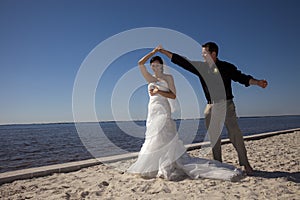 Wedding couple dancing on beach