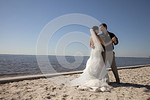 Wedding couple dancing on beach