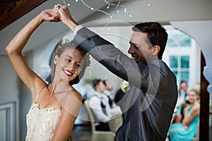 Wedding couple dancing in hall