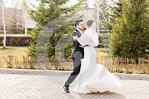 Wedding couple dancing in the park