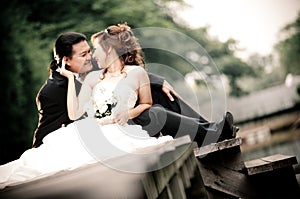 Wedding couple enjoying romantic moments outsides on a summer. Happy bride and groom on their wedding.