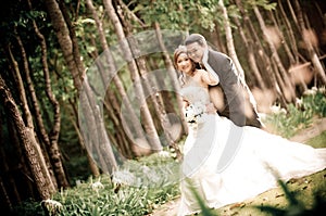 Wedding couple enjoying romantic moments outsides on a summer. Happy bride and groom on their wedding.