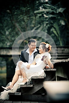 Wedding couple enjoying romantic moments outsides on a summer. Happy bride and groom on their wedding.