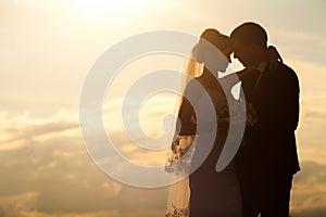 Wedding couple in the evening. Peaceful romantic moment.