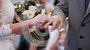 Wedding couple exchanging rings at ceremony