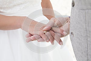 Wedding couple exchanging rings during wedding ceremony.