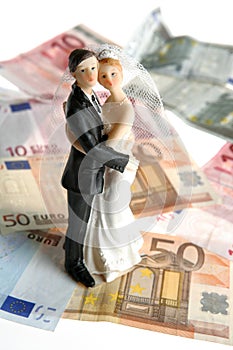 Wedding couple figurine over euro notes