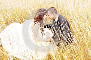 Wedding couple in grass. Bride and groom outdoors