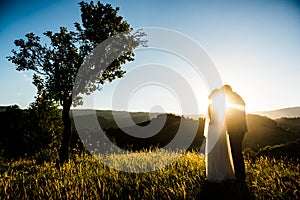 Wedding couple on a green field