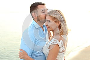 Wedding couple. Groom kissing bride