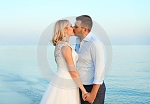 Wedding couple. Groom kissing bride