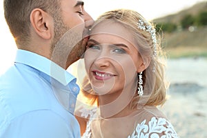 Wedding couple. Groom kissing bride