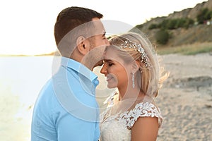 Wedding couple. Groom kissing bride