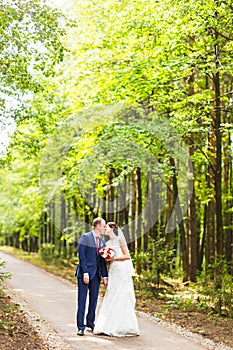 Wedding couple having fun and walk in the park