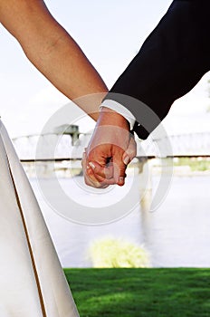 Wedding couple holding hands photo