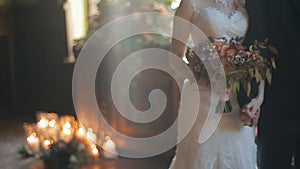 Wedding couple holding hands, happy groom and bride indoor. Young couple in love bride and groom, wedding day.