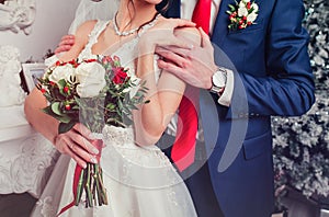 Wedding couple holding hands and hugging body part. Wedding detail
