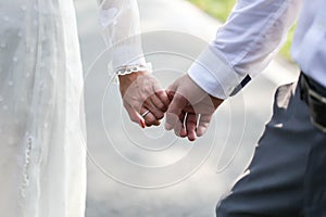 Wedding couple holding hands on sunset With Wedding Ring