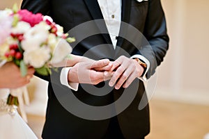 Wedding couple is holding hands